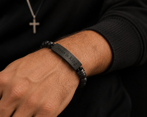 Man wearing the black Jesus Is King Bracelet for Men by Cornerstone