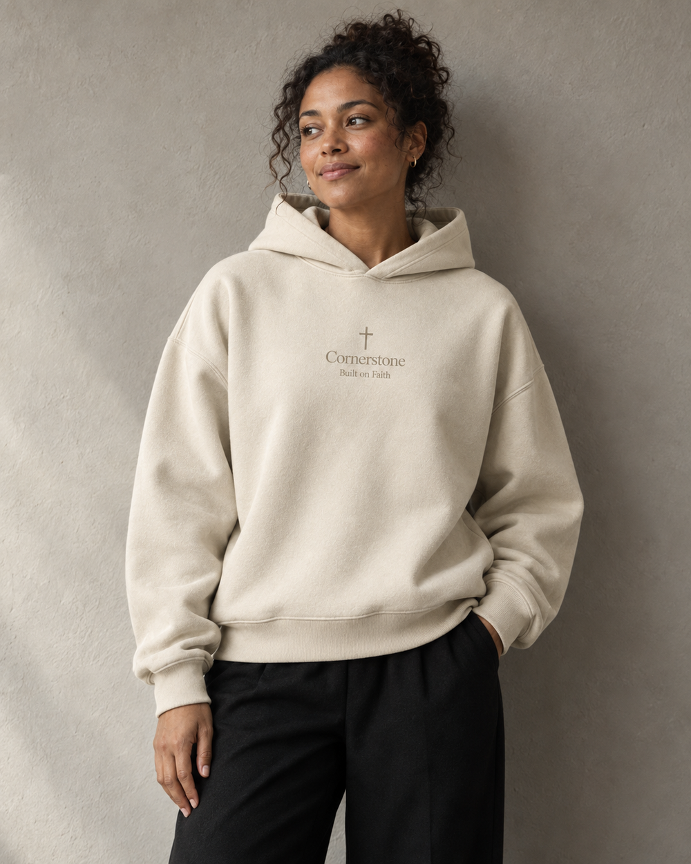Woman wearing the cream Cornerstone hoodie